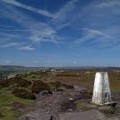The walk along the top of Stanage Edge with the trig point of High Neb in the foreground