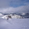 Summit trig point in the snow, Ben Alder