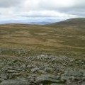 Looking north west from the summit of Cairn Bannoch towards Carn an t-Sagairt Mòr with the Cairngorms beyond